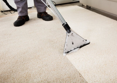 Person Cleaning Carpet With Vacuum Cleaner